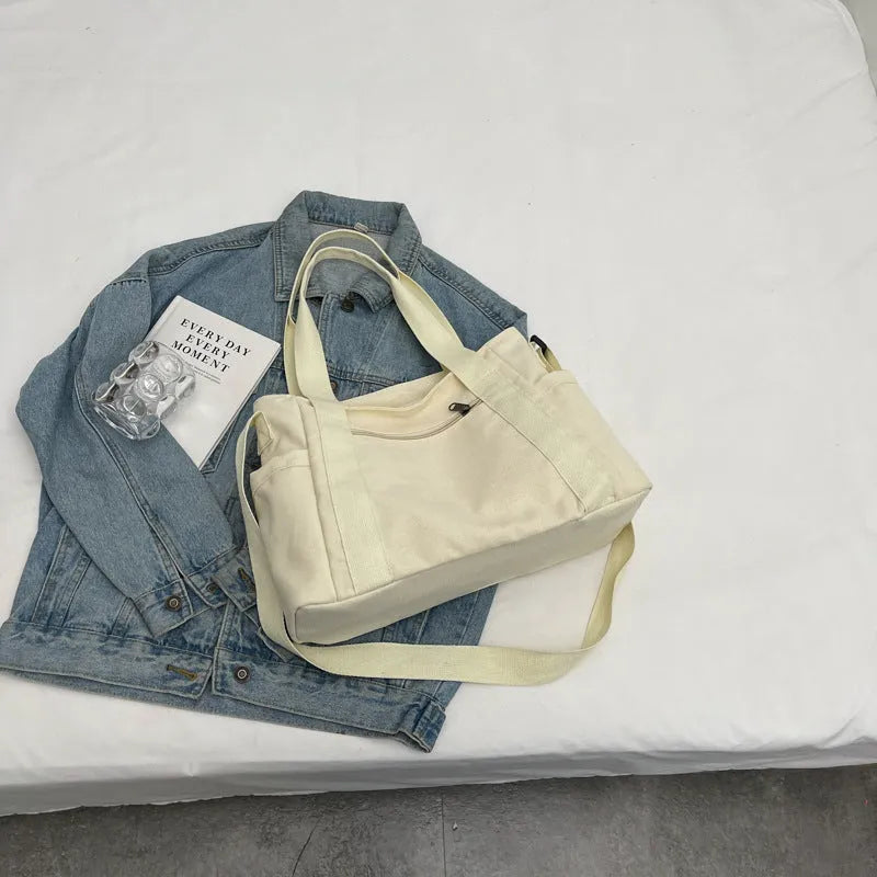 Large canvas shoulder tote bag in solid colour with sandwich pocket organisation