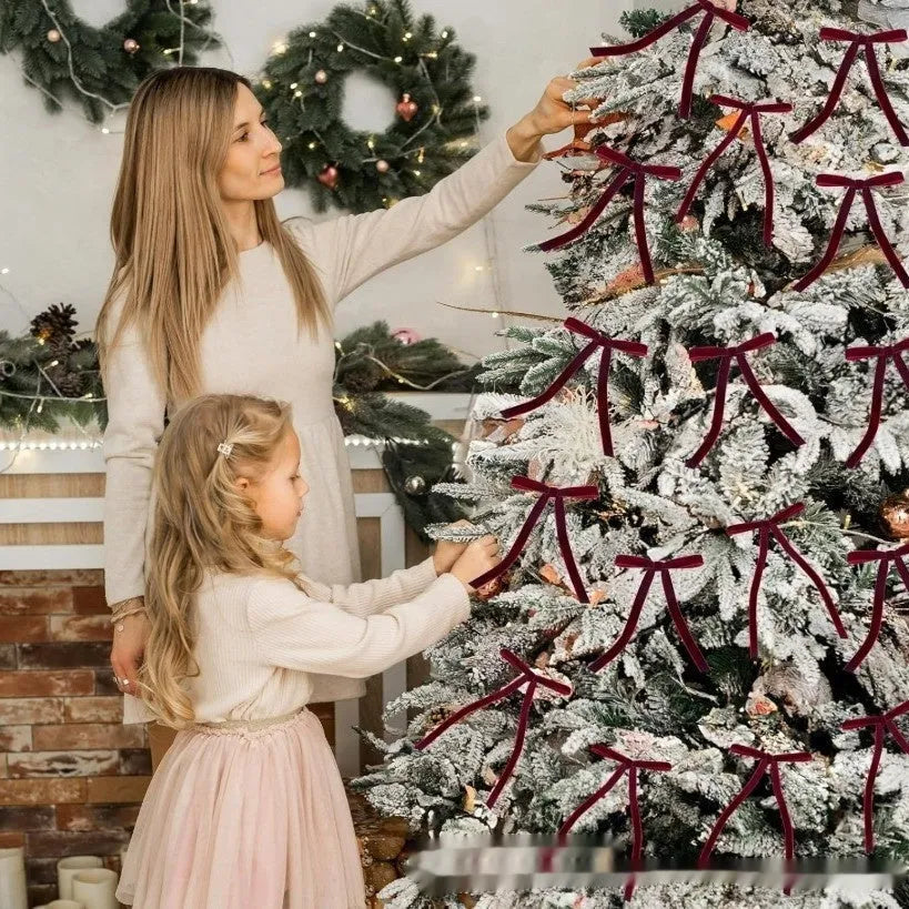 Velvet ribbon Christmas tree strap pendant decoration in a selection of colours including red and gold on a tree branch