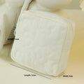 Quilted silk cosmetic storage bag in candy colours showing pink, yellow, blue, white, and green options