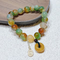 Yellow gold tone peacock agate and old mine topaz bracelet with peace buckle closure