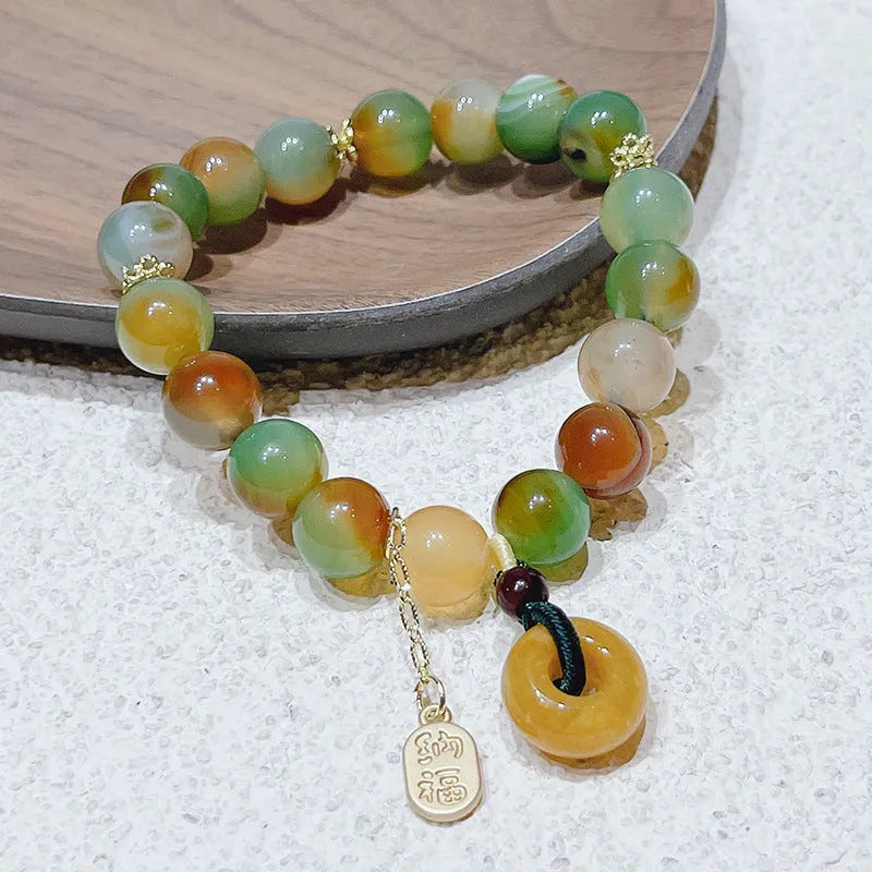 Yellow gold tone peacock agate and old mine topaz bracelet with peace buckle closure