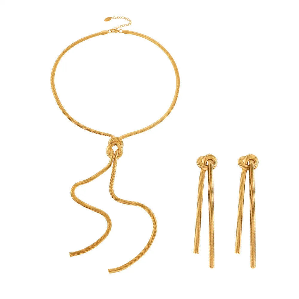 Gold plated titanium steel necklace with snake chain and knotted tassel pendant, shown with matching earrings.