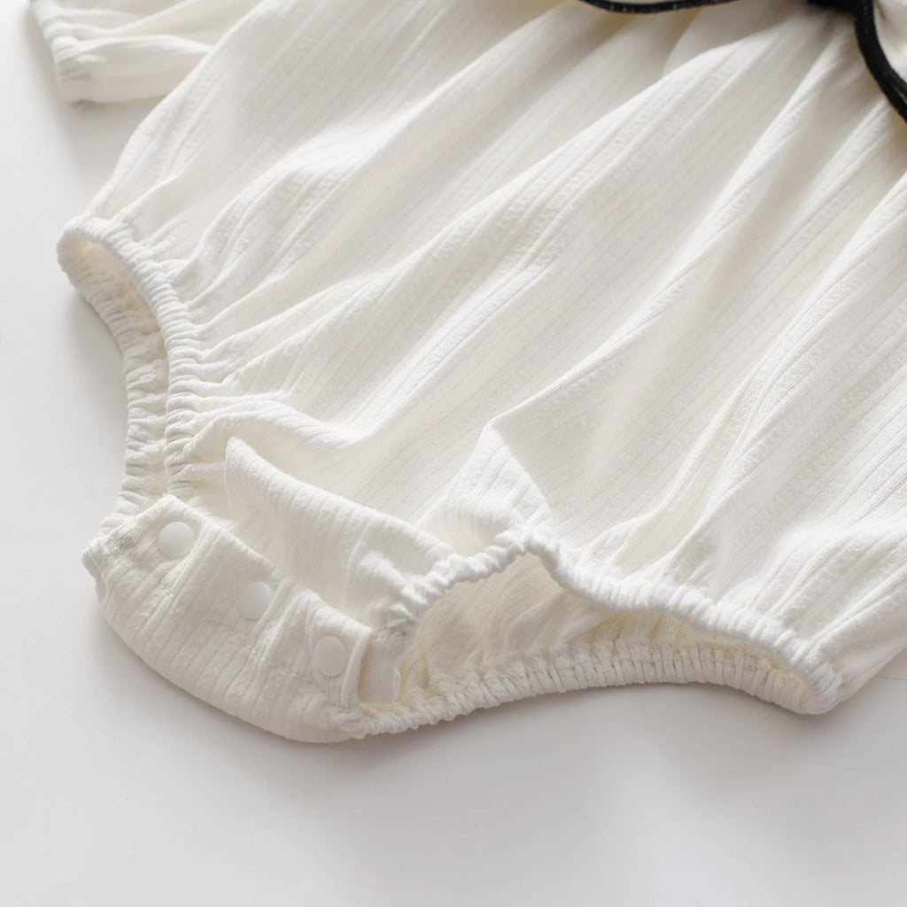 Cotton baby bow long sleeve onesie in black or white, triangle jumpsuit style, sizes 66-100cm