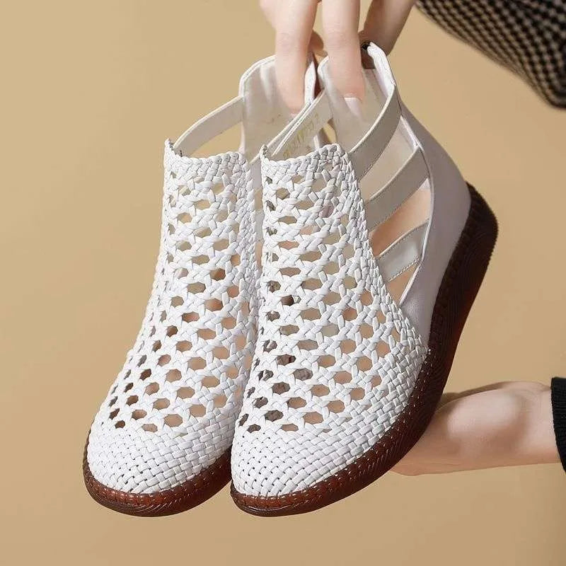 Women's flat gold sandals with hollow-out design and soft sole.