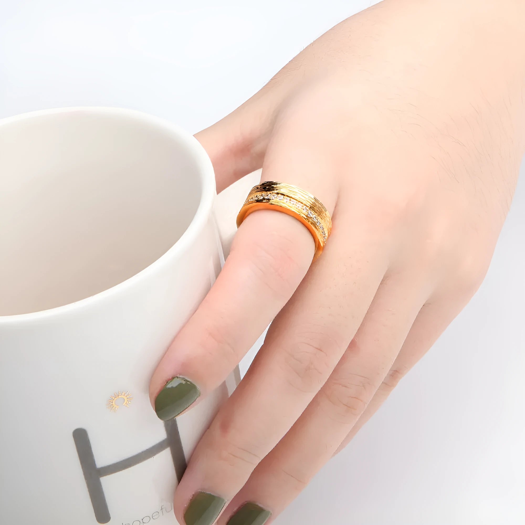 Gold geometric women's zircon ring on a copper base, shown in size 7.