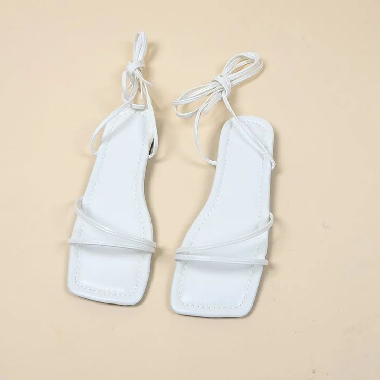 Women's flat sandals with ankle ring bandage strap and front lace-up fastening in square toe design.
