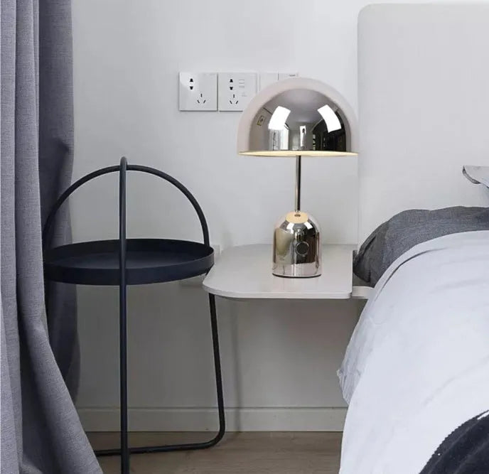 Mushroom-shaped table lamp with metal base in chrome, gold, or rose gold finish on wooden table