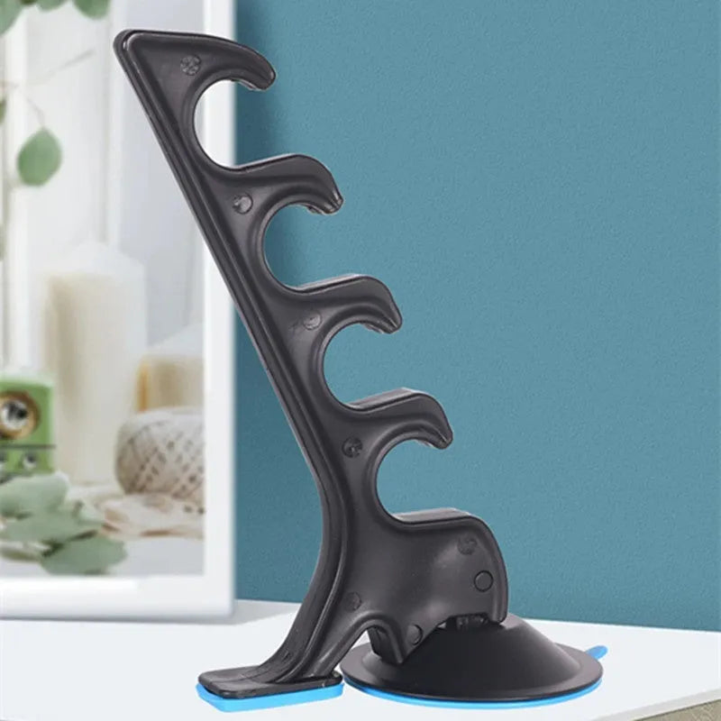 Black plastic car fishing rod bracket with suction cup mount for holding one fishing rod in a vehicle.