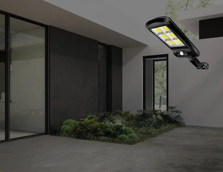Black solar motion sensor outdoor light with IP65 waterproof rating for garden and pathway illumination