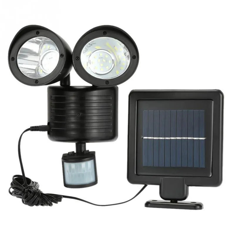 Black dual-head solar security spotlight with motion sensor mounted on exterior wall