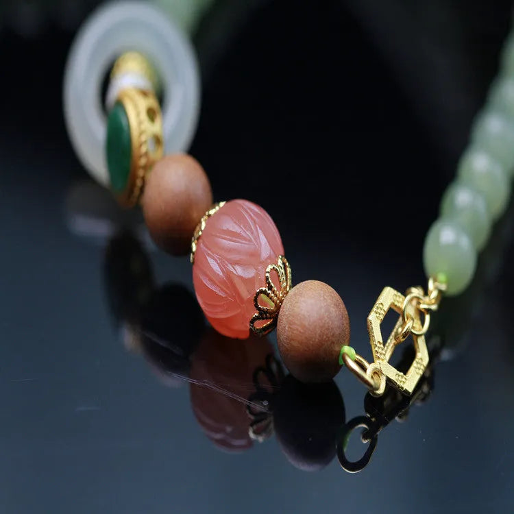 Hetian jade and sandalwood necklace with lotus beads and animal pendant, plus matching bracelet.