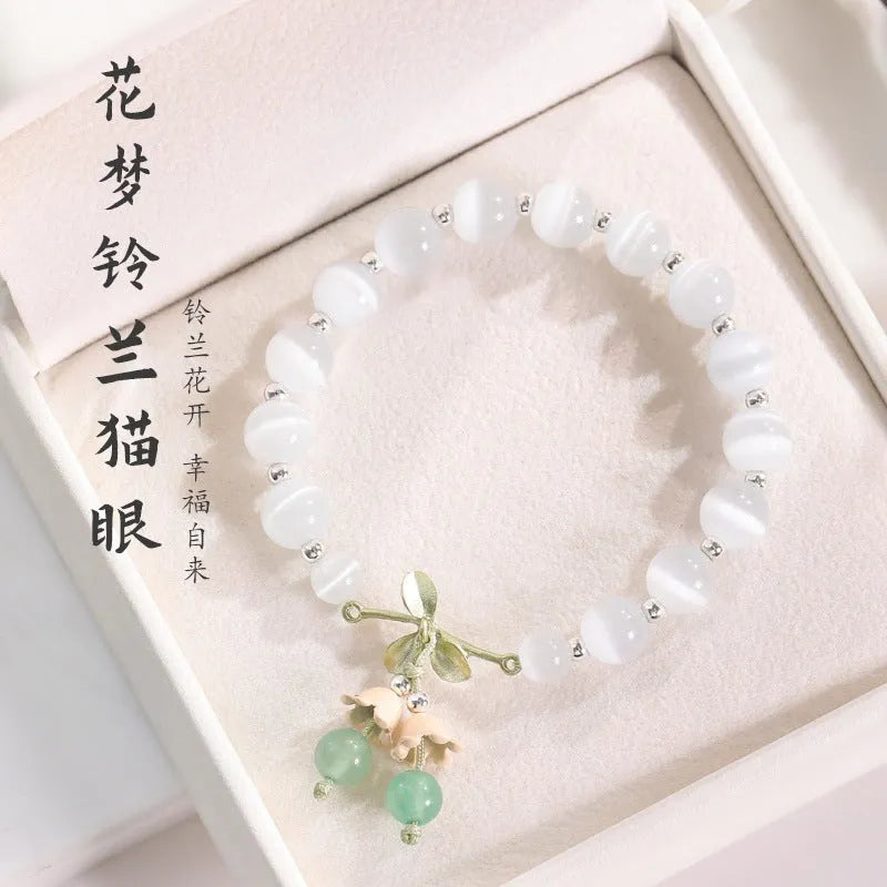 Women's beaded bracelet with diamond-shaped cat's eye opal stones in multiple colour options on a wrist.