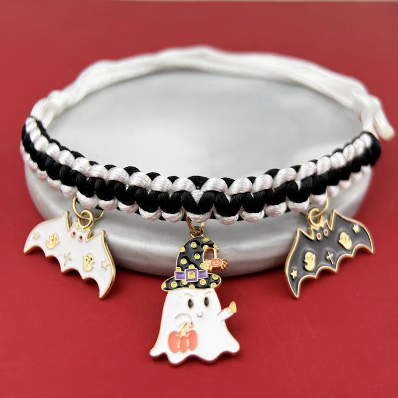 Zinc alloy Halloween charm on a pet collar, showing geometric pattern and clip.