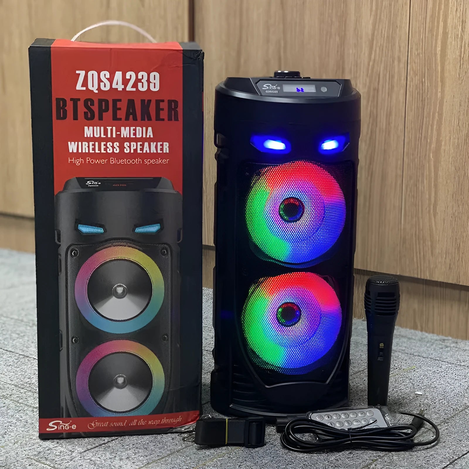 Black portable Bluetooth speaker with colourful dual horns, showing front panel with controls.