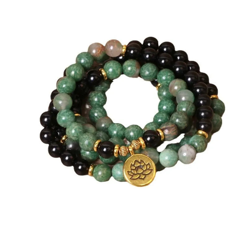 Green and black alloy bead elastic bracelet on a black stretch cord.