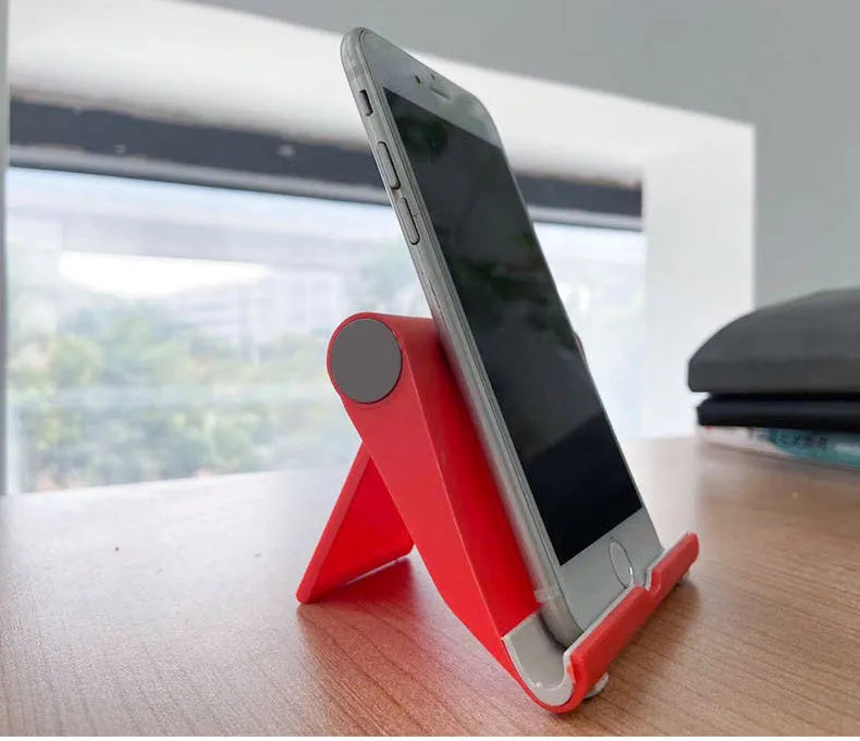 Folding mobile phone tablet stand in multiple colours showing adjustable angle mechanism