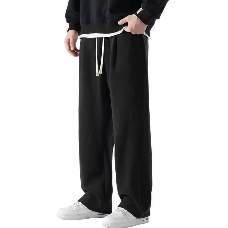 Men's apricot coloured loose-fit polar fleece-lined casual winter trousers on a white background.