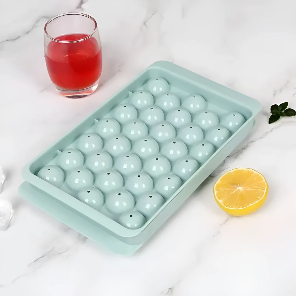 Silicone ice cube tray with lid in blue or pink, showing 33 round ice moulds measuring 24x14 cm.