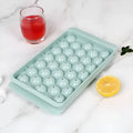Silicone ice cube tray with lid in blue or pink, showing 33 round ice moulds measuring 24x14 cm.