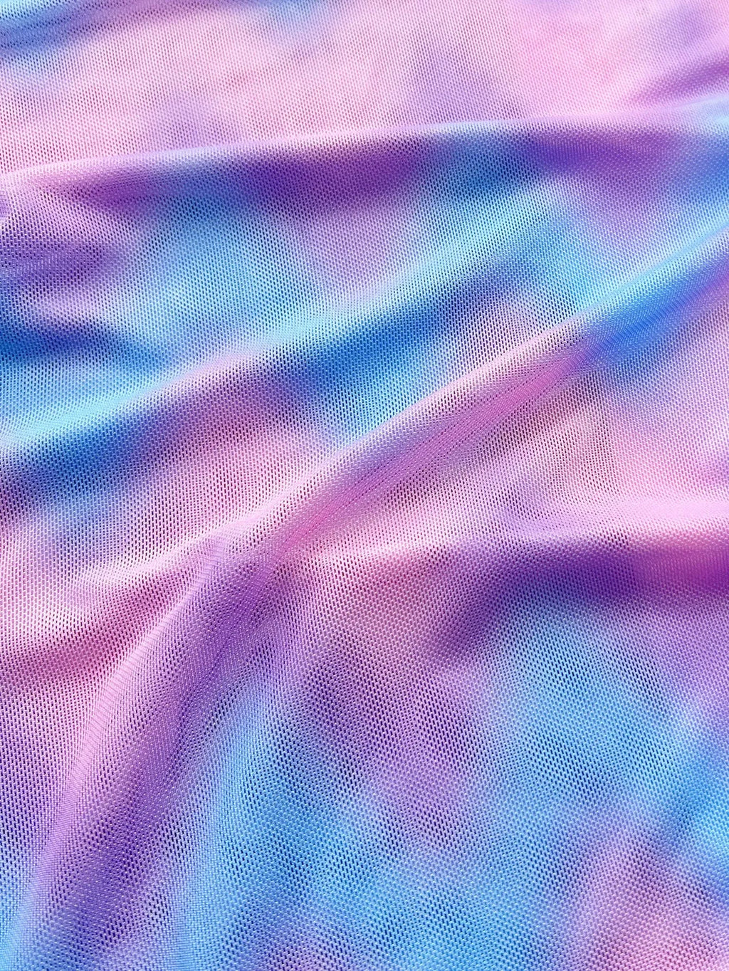 Women's tie-dye bikini swimsuit set with a skirt, bra, and matching briefs.