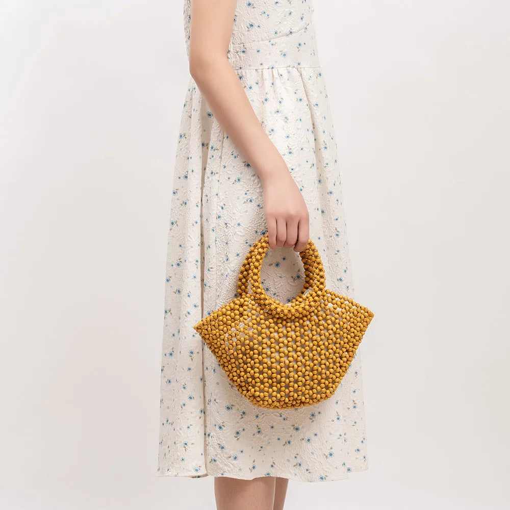 Hand-woven maple wood beach bag with wooden bead decoration in dumpling shape