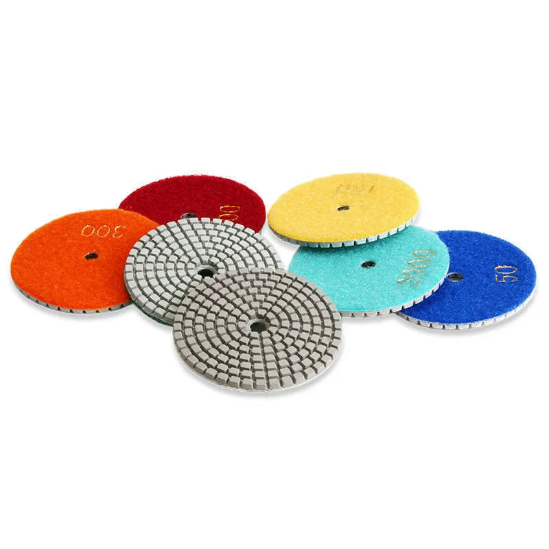 Set of 10 emery stone polishing pads showing 80mm diameter discs with central mounting holes