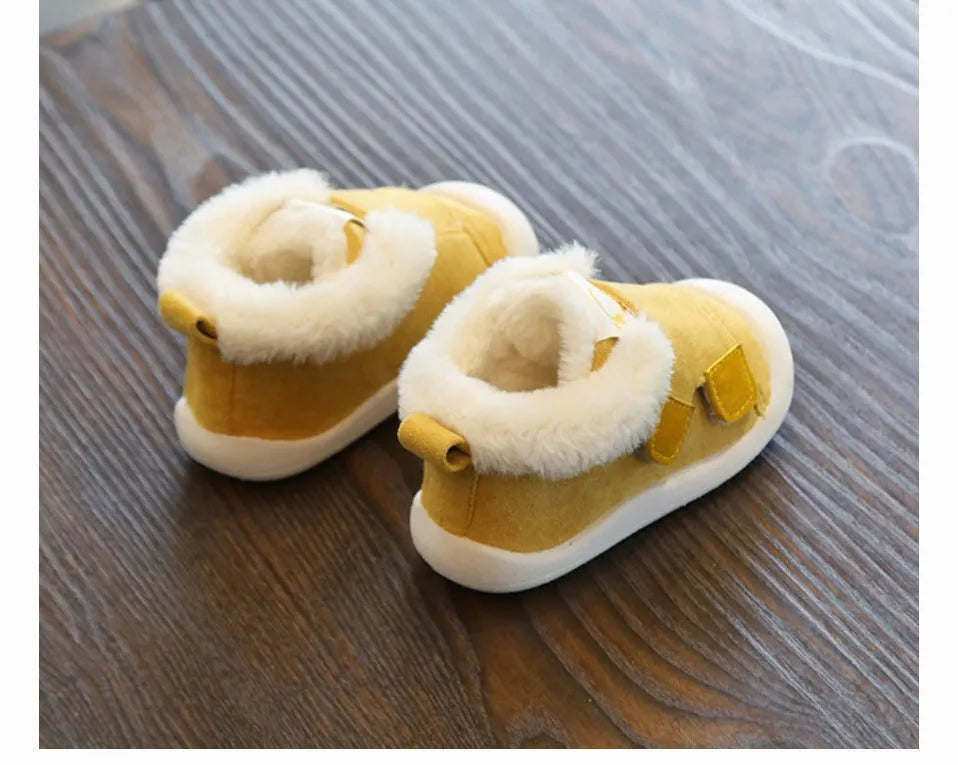 Children's velvet toddler shoes in various colours, showing non-slip sole and soft upper.