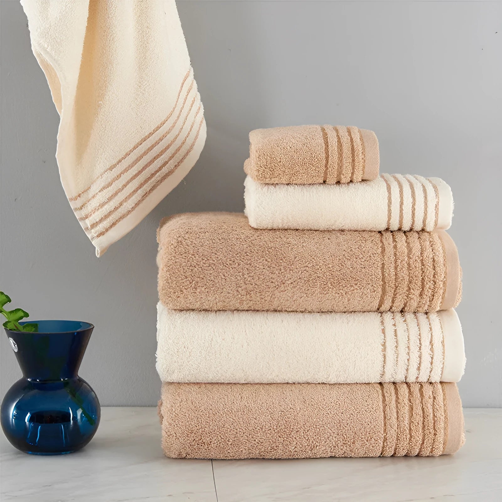 Cotton towel set showing beige and brown options with 34cm and 70cm sizes