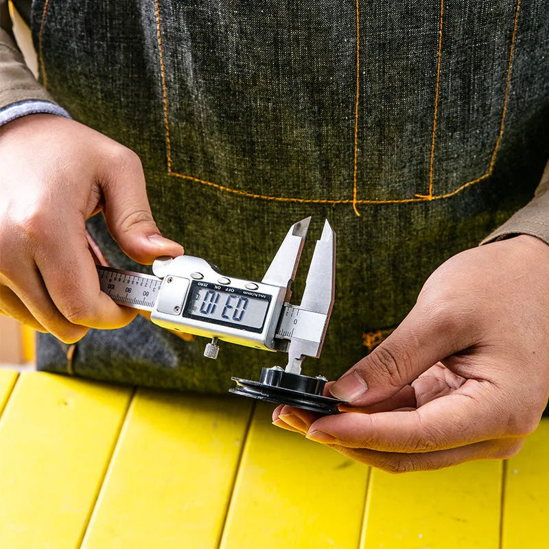 Deli stainless steel digital vernier caliper with LCD screen showing measurement.