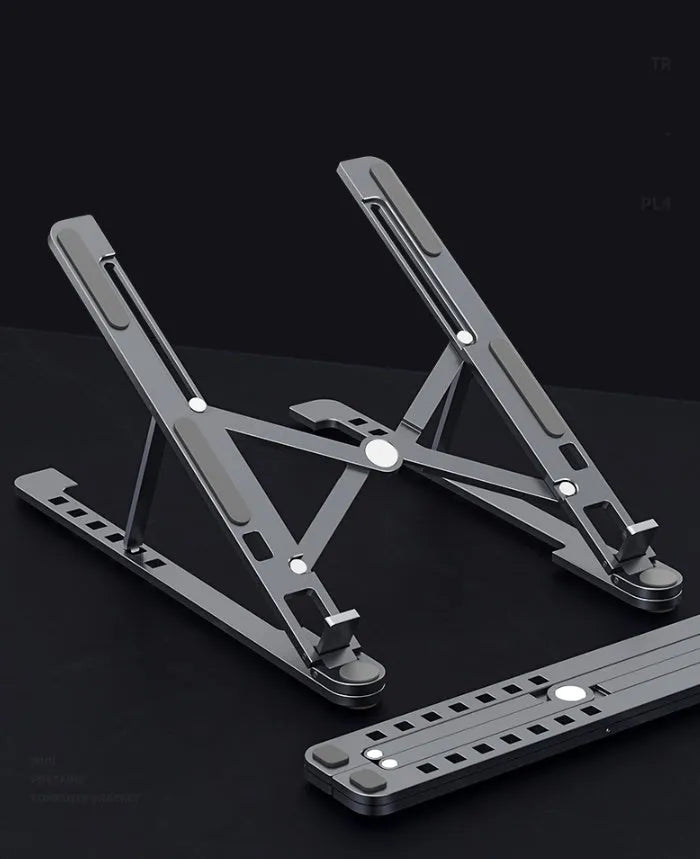Foldable aluminium laptop stand in silver colour, shown adjusted to a height with a laptop on it