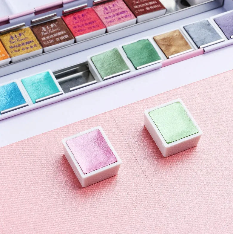Solid watercolour paint palette showing pearl-effect colour pans in 12 and 24 set options.