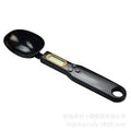White digital spoon kitchen scale with LCD display showing weight measurement