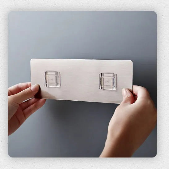 White plastic wall-mounted magnetic knife rack holding several kitchen knives