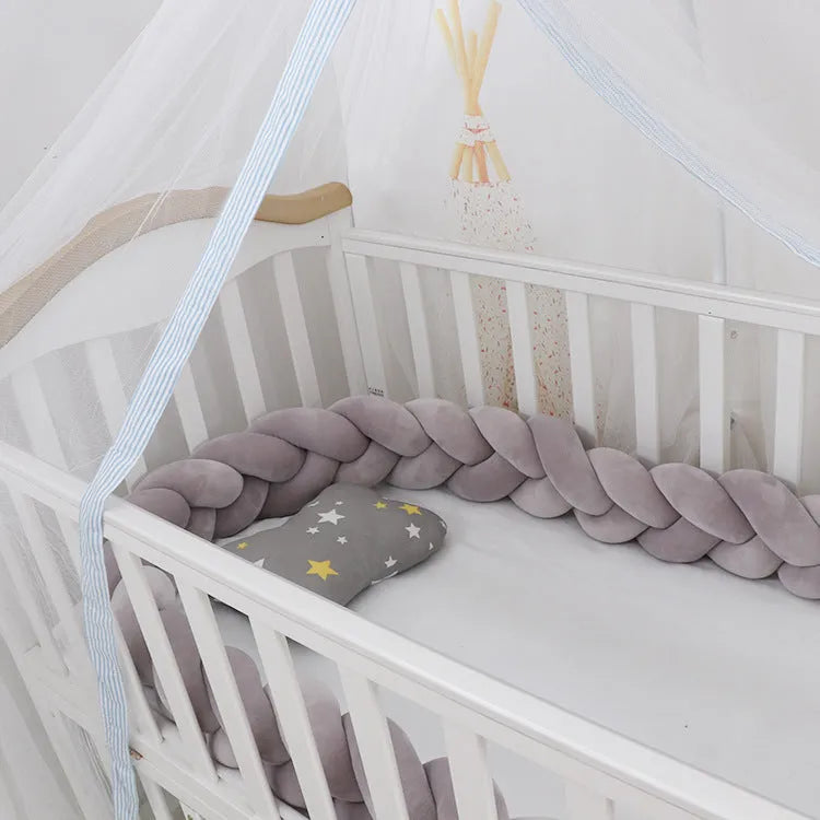 A bendable baby crib bumper in spandex crystal velvet, shown in a bright colour, shaped around a cot.