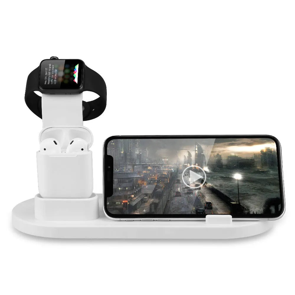 White headphone charging stand with dual USB ports on a wooden desk next to wireless headphones.