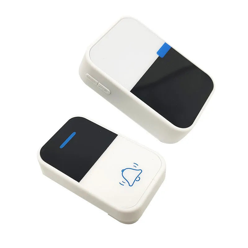 Modern white plastic wireless doorbell receiver and transmitter on a table.