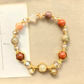 Gold crystal bracelet with 8mm beads showing hand-woven construction and traditional auspicious symbols