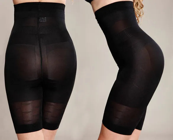 Black seamless high-waist shapewear shorts laid flat, showing the tummy control panel and leg openings.