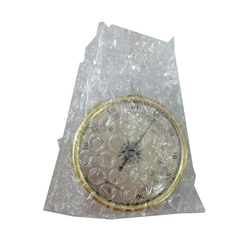 Analog thermometer and hygrometer with silver aluminium ring and dial showing temperature and humidity scales.