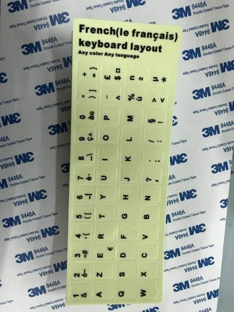 Yellow glowing keyboard stickers showing Arabic, Thai, Hebrew, French, Italian and German characters on PVC sheet