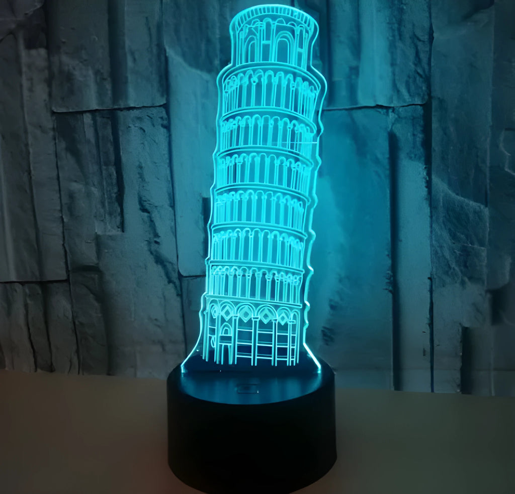 3D acrylic Leaning Tower of Pisa night light glowing in blue on a black base with remote control.