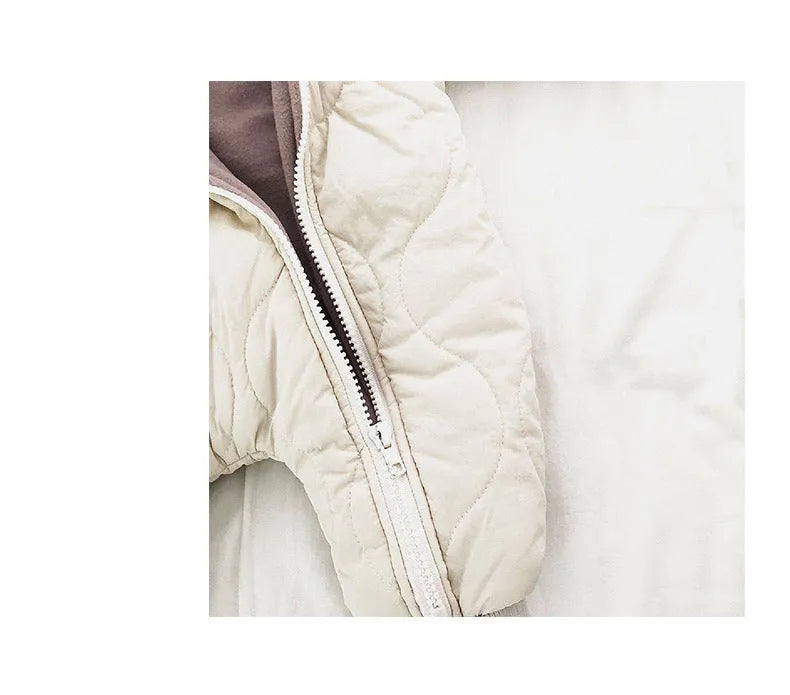 Baby padded quilted cotton kumpsuit in beige with attached hat and long sleeves, shown on a white background