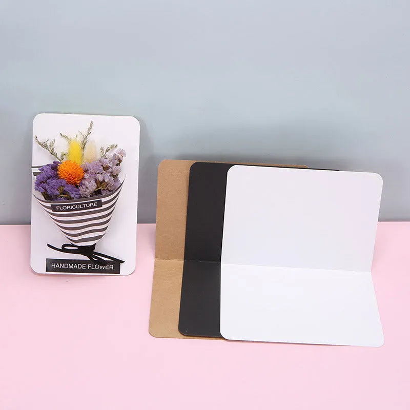 Pack of 100 folded kraft cards in 10x15 cm size, showing black, cowhide, and white colour options.