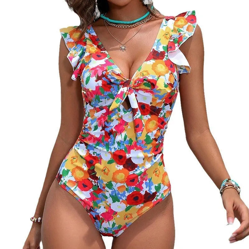 Women's printed one-piece swimsuit in polyester fabric showing conservative cut and high elasticity