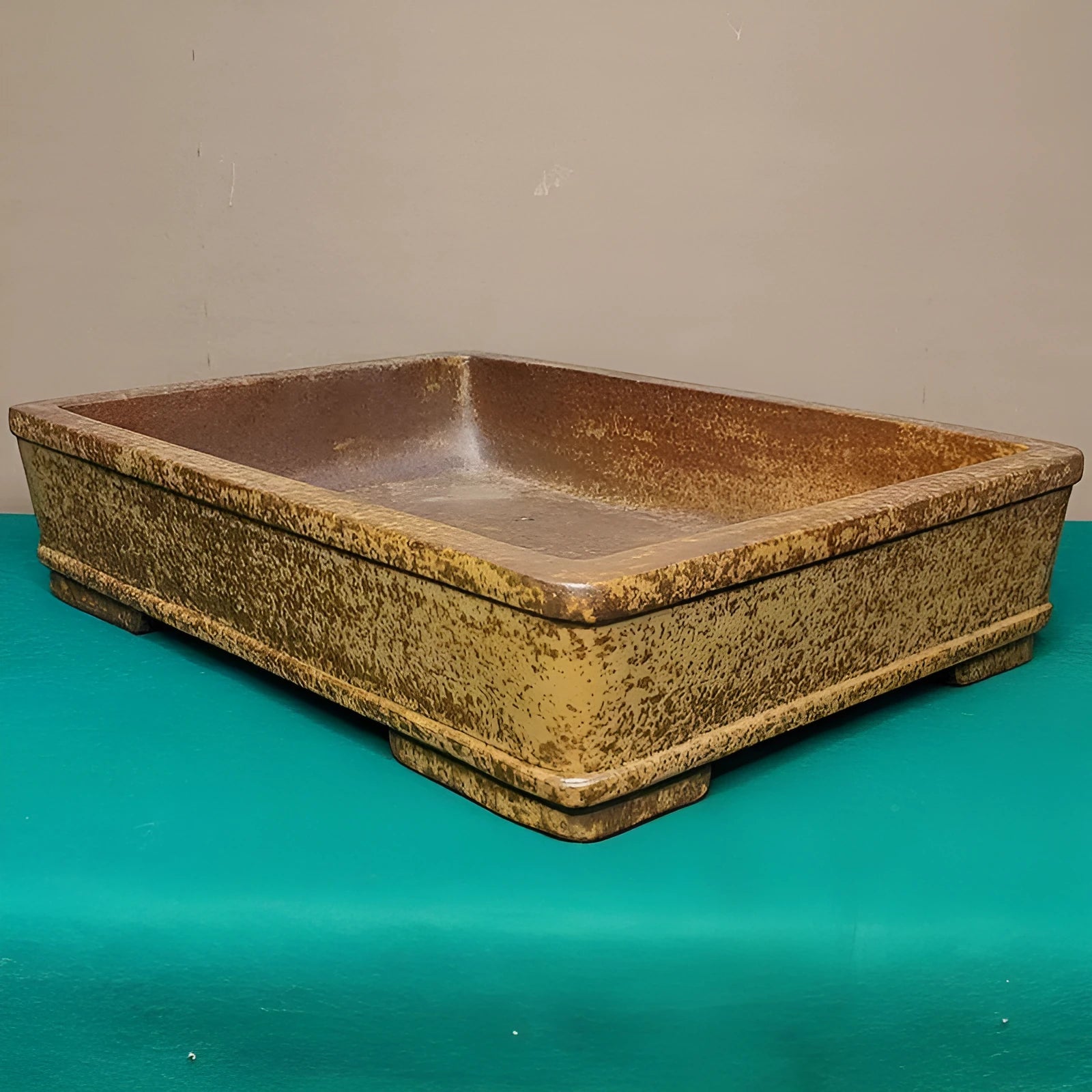 Straight shallow rectangular Yixing purple sand flowerpot for plants on a surface.