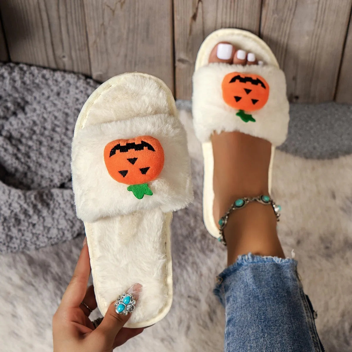 Pumpkin-themed plush slippers with open toe design and anti-slip PVC soles in white and yellow colour options
