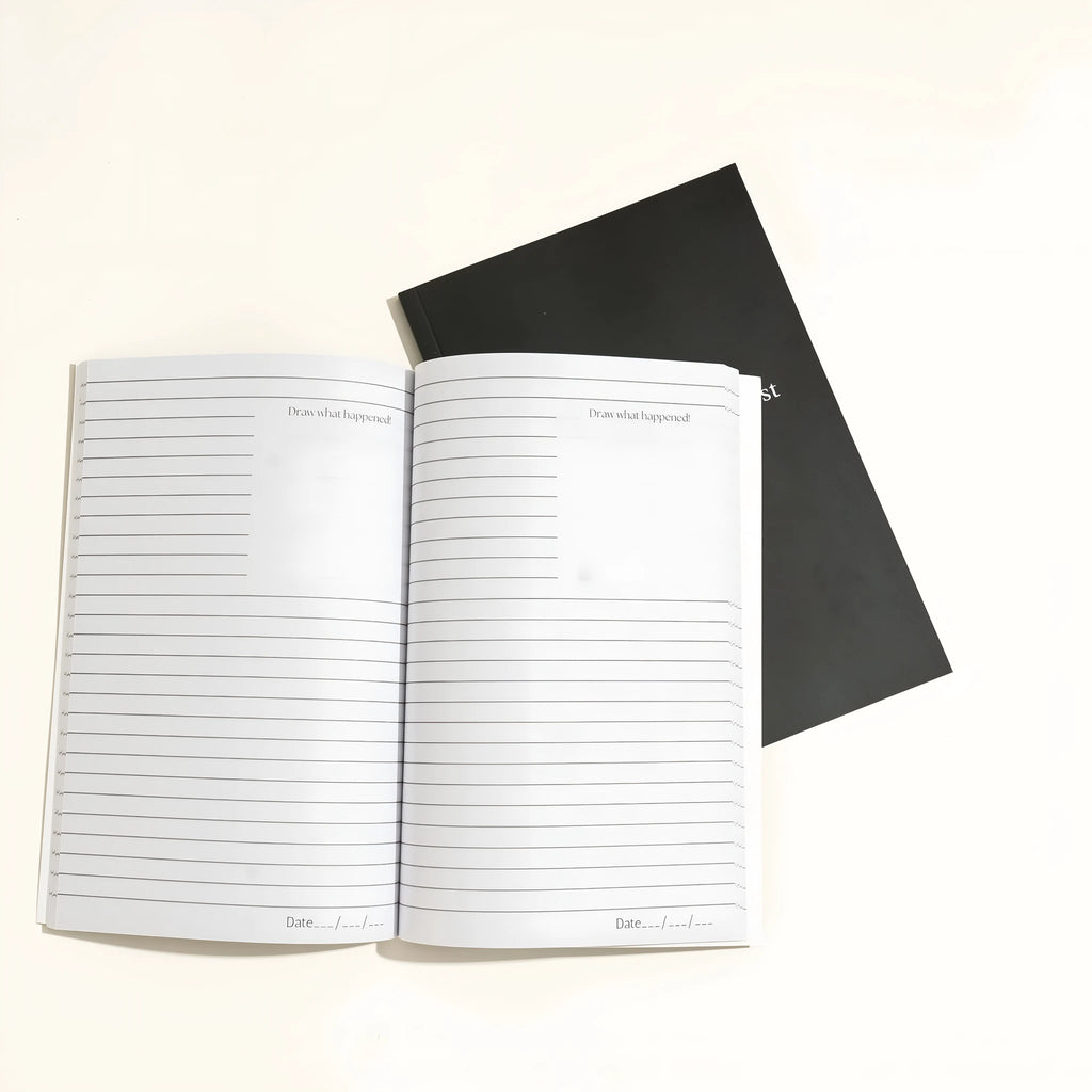Black A5 hardcover dream journal notebook with lined paper and a ribbon bookmark.