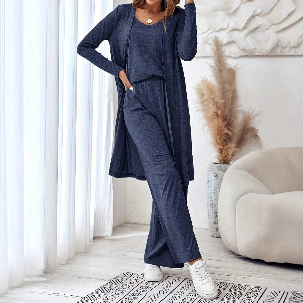 Blue women's three-piece suit set with top, trousers, and suspenders on a hanger
