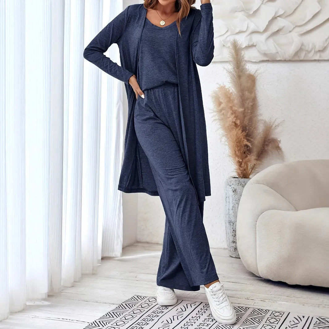 Blue women's three-piece suit set with top, trousers, and suspenders on a hanger