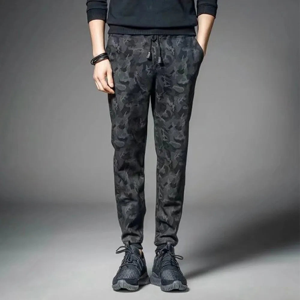 Men's black jogging pants made from acetate and modal fabric, side view on model